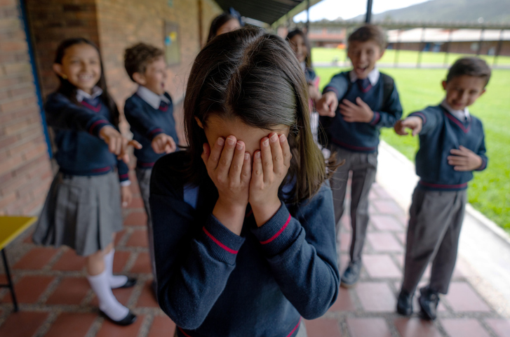 Girl crying while being bullied at the school