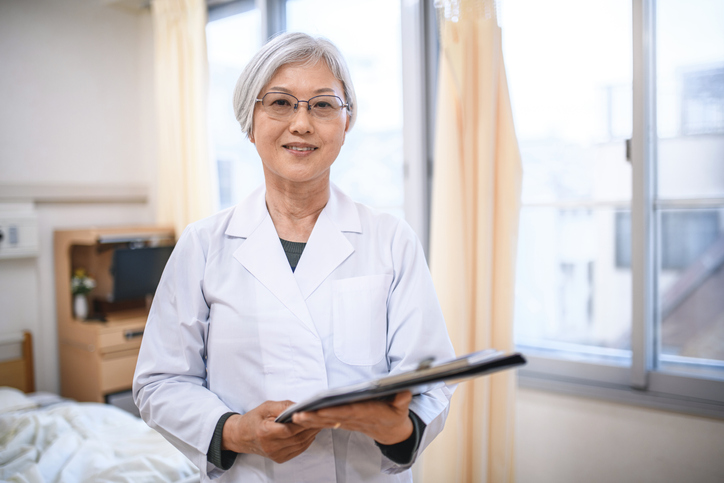 Relaxed Senior Female Japanese Doctor in Hospital Room