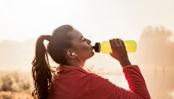 Young woman Refreshing after running