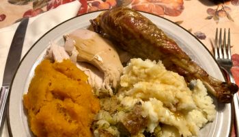 Turkey dinner with mashed potatoes, squash, stuffing, and gravy