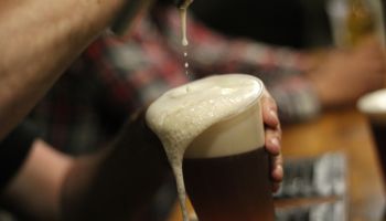 Cropped Hands Of Man Pouring Beer In Glass