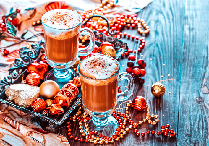 Two Cups of Hot Coffee or a Cappuccino on Tray with Christmas Decorations on Wooden Background