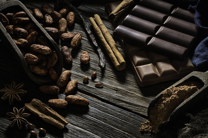 Assorted chocolate with cocoa powder and dried cocoa beans in old fashioned style