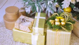 Close-Up Of Christmas Presents By Tree On Floor