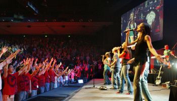 The crowd waves their arms in unison at the Panetshakers meeting at Hillsong Chu