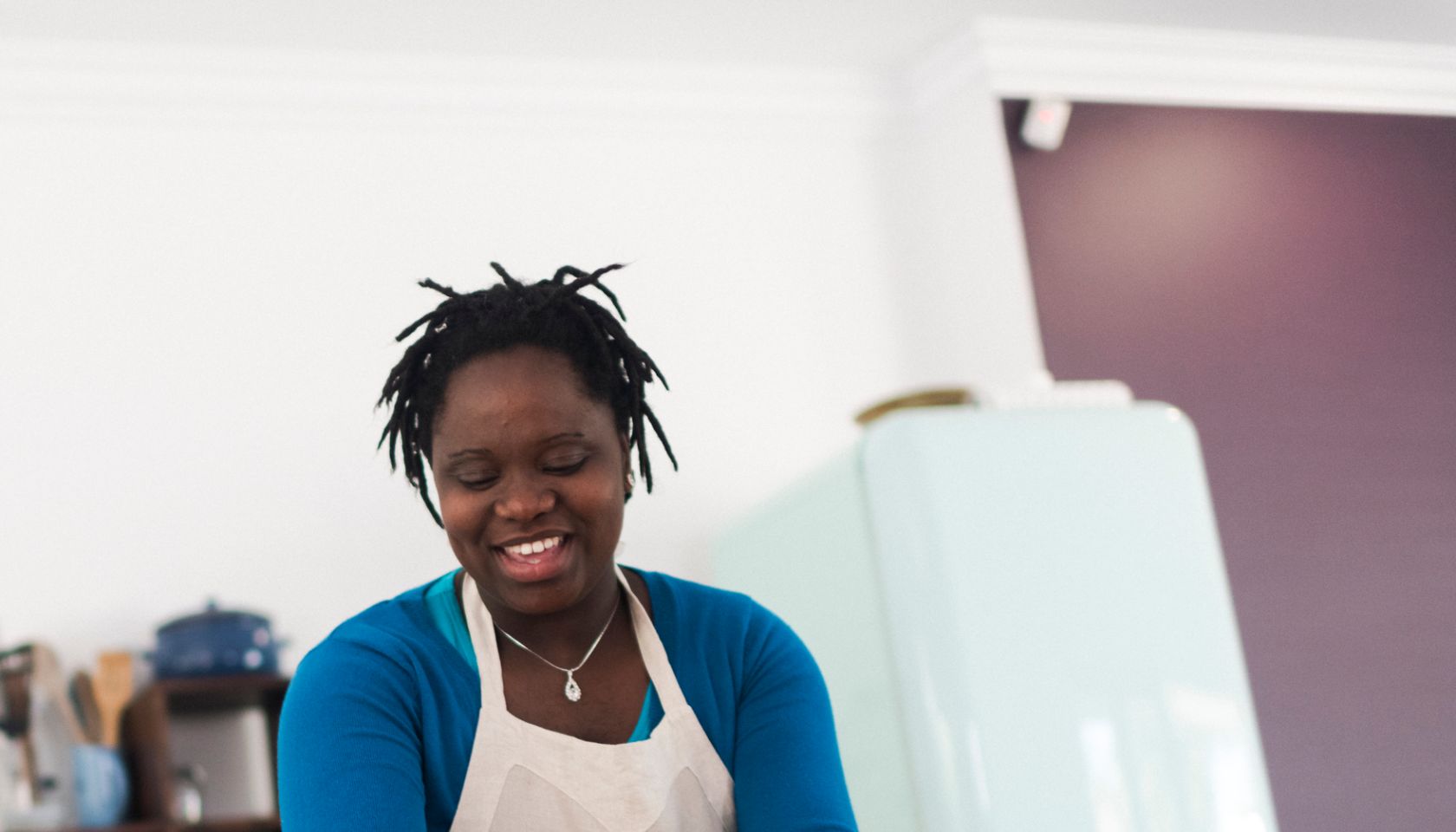 Low angle view of a smiling mother preparing a meal in her kitchen