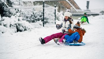 Children sledding in winter.