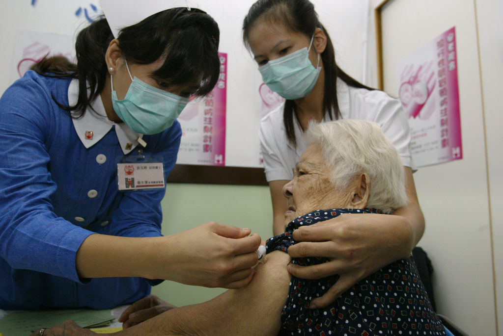 An elderly woman receives a Influenza vaccination at a elderly home by a nurse on programme for the elderly. 10 NOVEMBER 2003