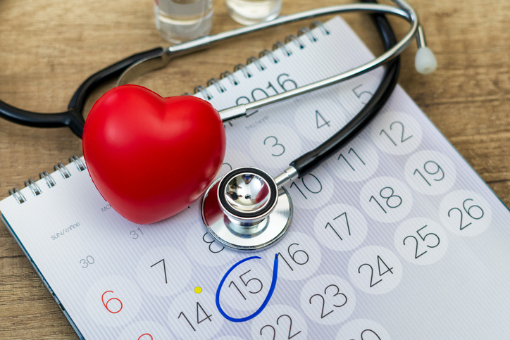 Red heart and stethoscope on calendar with due date.Concept of health and heart