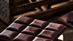 Chocolate bars in rustic wooden table