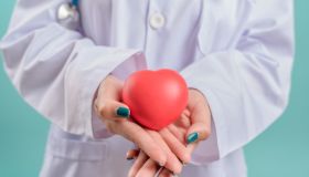 Doctor hands holding red heart, love and health medical and insurance concept