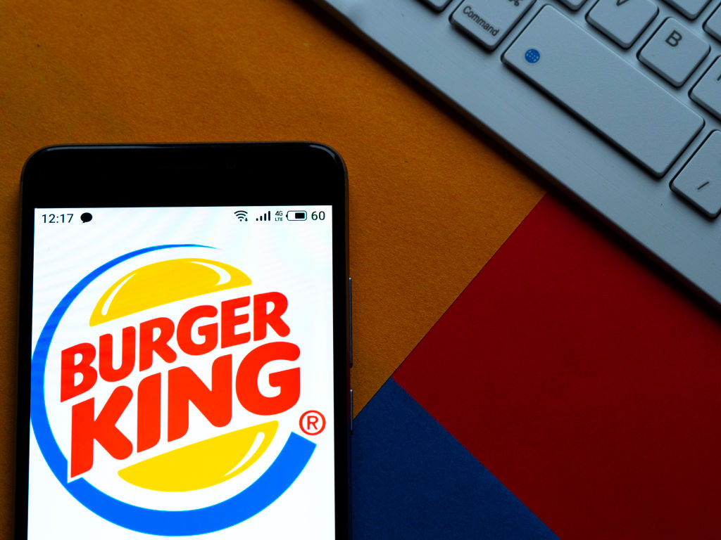 In this photo illustration a Burger King logo seen displayed...