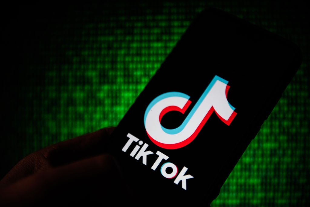 In this photo illustration a Tik Tok logo seen displayed on...