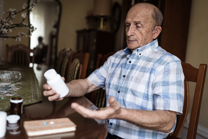 Elderly man taking medicine