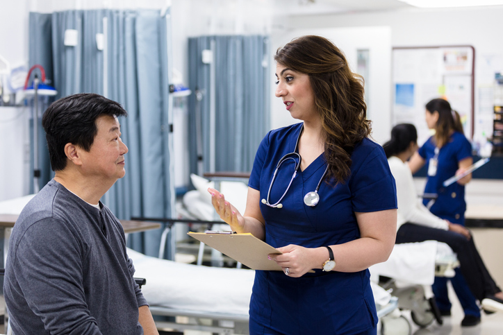 Serious female doctor talks with patient