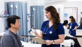 Serious female doctor talks with patient