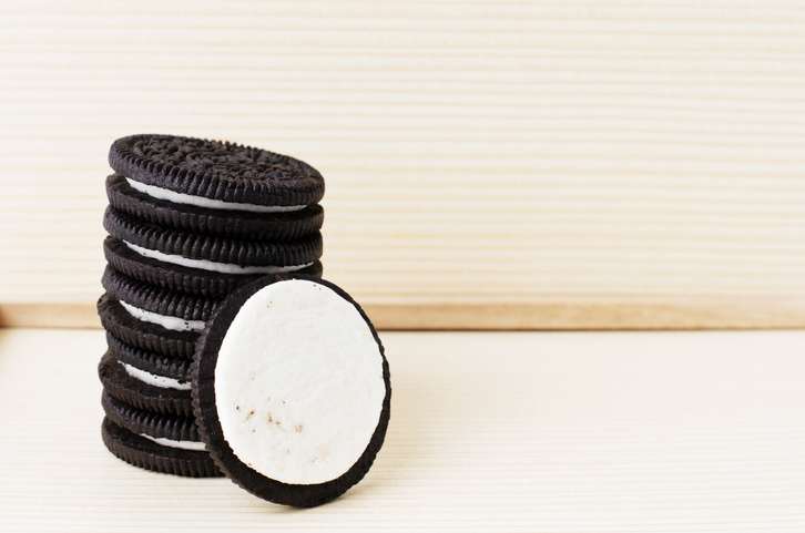 Close-Up Of Sandwich Cookie Stack On Table Against Wooden Tray