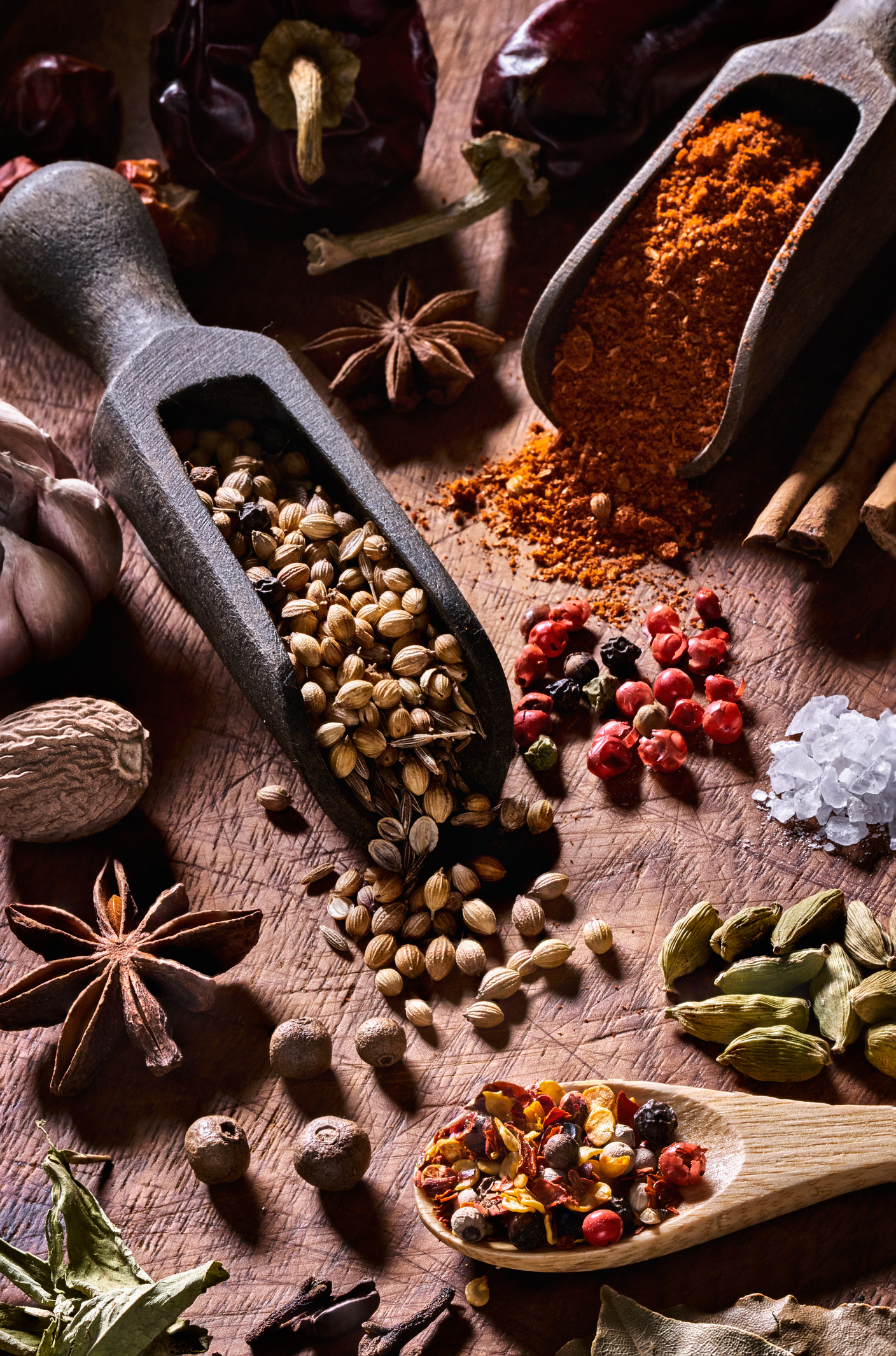 Variety of allspice and herbs on rustic wood table