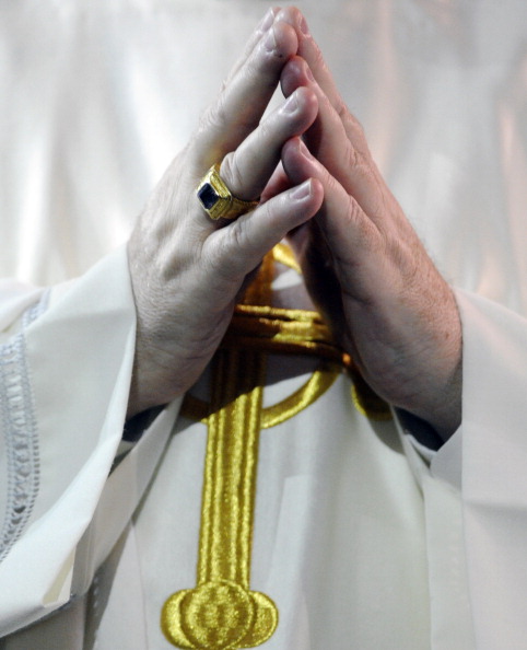 DENVER, CO-- A clergy member clasps his hands together on the Pulpit during Communion for "The Holy Sacrifice of the Mass," opening the 129th Supreme Convention for the Knights of Columbus international convention at the Sheridan Hotel in downtown Denver