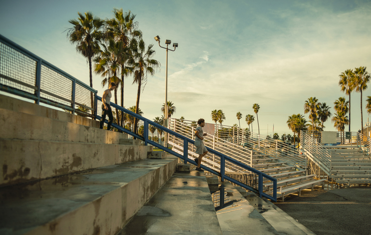 The young Hispanic athlete doing steps running on the outdoor public stadium