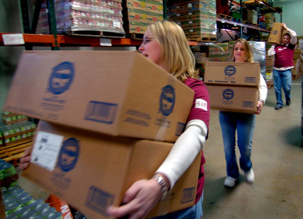 DENVER, COLO. - MARCH 4, 2005 - Patty Colee , front, Chandra Lay , middle, and Patrick Batten , rear, of the Gap, Inc. store at the Park Meadows Shopping Center , three of the store's volunteers at Food Bank of the Rockies in Den