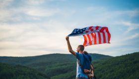 Group of hikers waving with American flag