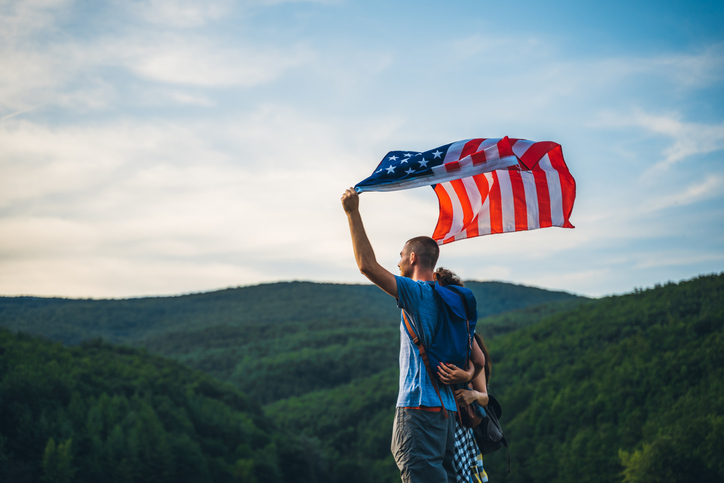 Group of hikers waving with American flag