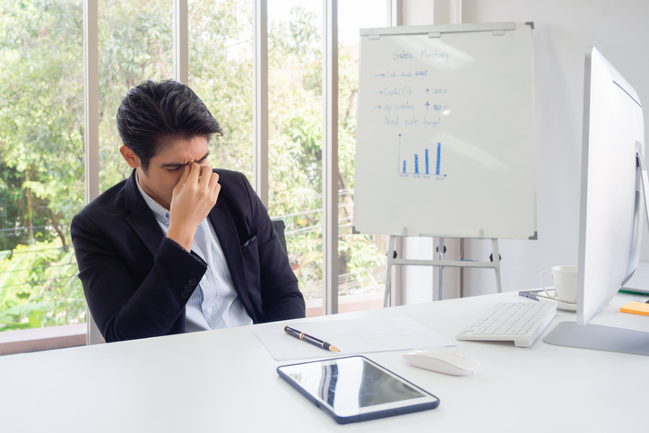 Young Depressed Businessman Sitting At Office