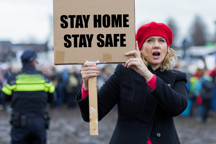 Beautiful blonde woman protester during Covid-19 crisis